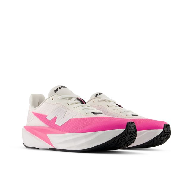 Pair of New Balance FuelCell kids running shoes in cream and hot pink