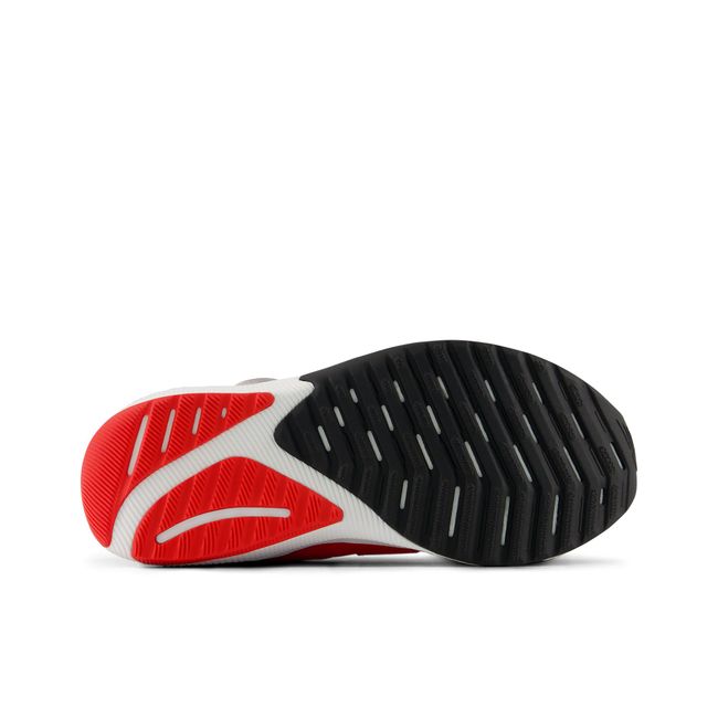 New Balance DynaSoft Reveal V4 BOA kids running shoe in red and orange, outsole view.