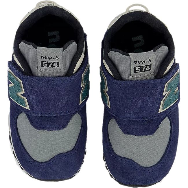 Top-down view of New Balance 574 sneakers in navy with a gray accent and a velcro closure.