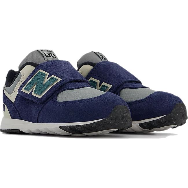 Pair of New Balance 574 sneakers in navy with a gray accent and a velcro closure.