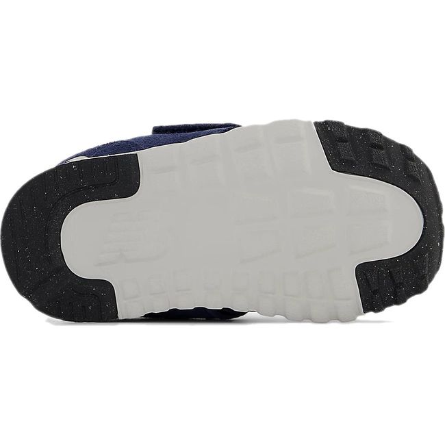 Sole of New Balance 574 sneakers in white with pieces of black tread