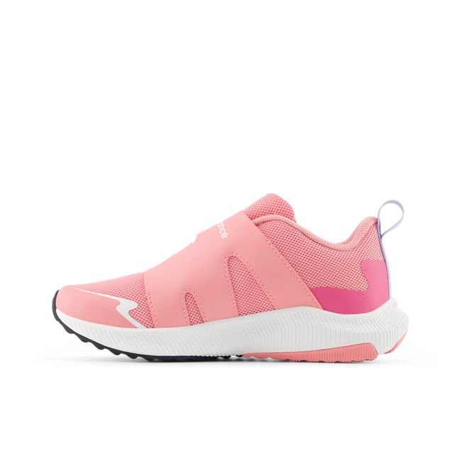 Medial profile of the New Balance Reveal v4 BOA in coral pink with a white midsole
