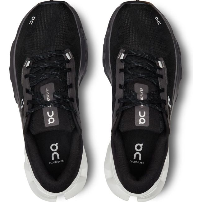 Top-down view of On Cloud Cloudflyer 5 running shoes in black with a white sole at the heel
