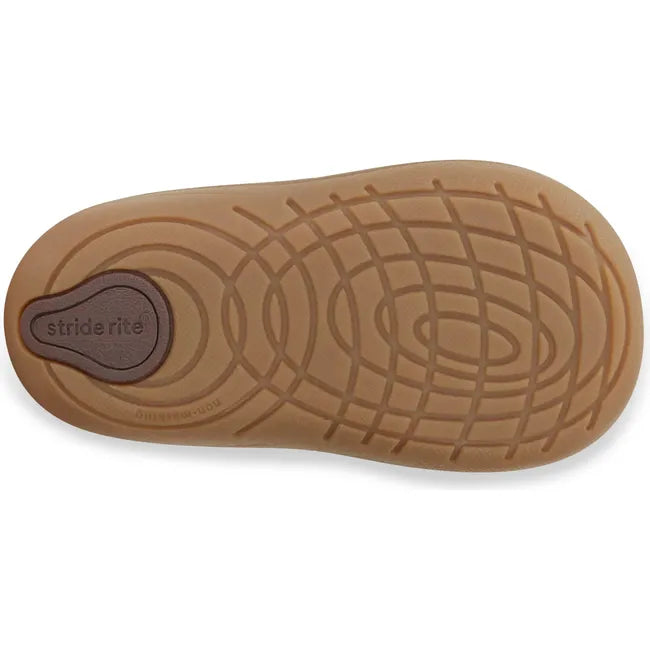 Sole of Kids Stride Rite Gannon Boot in brown leather upper with tan flexible sole