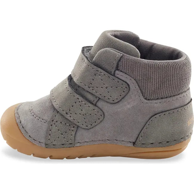 Medial side of Stride Rite Kids Shoes Martin Boot in grey with two velcro straps and tan sole