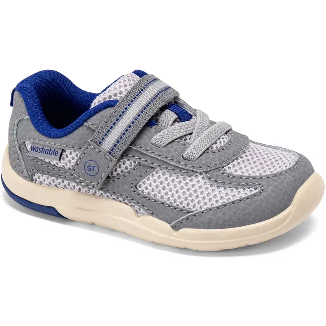 Angled view of Stride Rite Kids’ Ian 2.0 Sneaker in grey with velcro strap and elastic laces