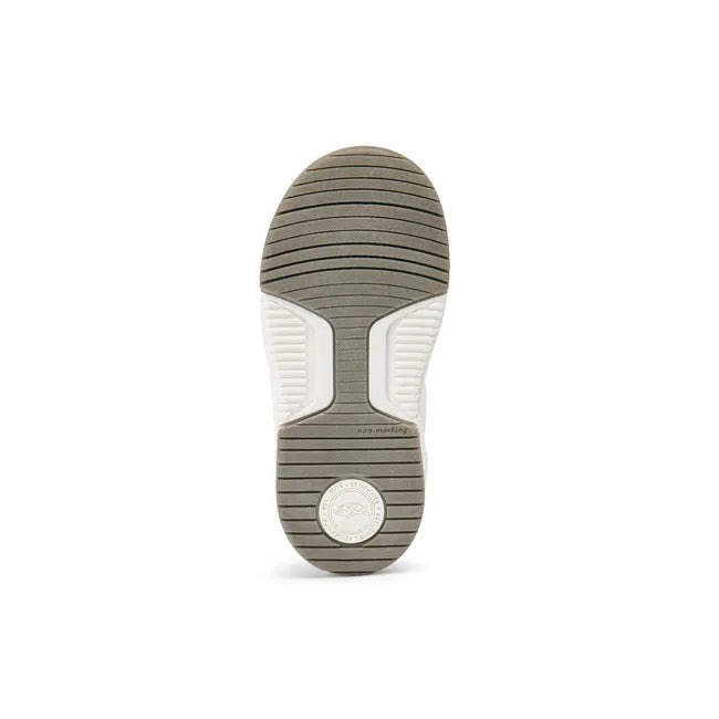 White sole of Stride Rite Kids' Denver Sneaker in olive, white, and black leather upper