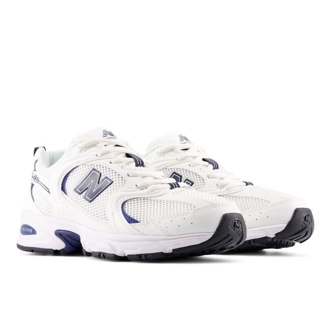 Pair of New Balance 530 retro sneakers in white and deep navy