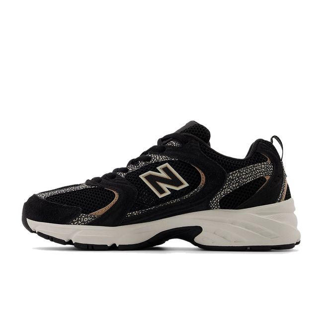 Medial side of New Balance Unisex 530 Lifestyle Shoe in black and flat taupe