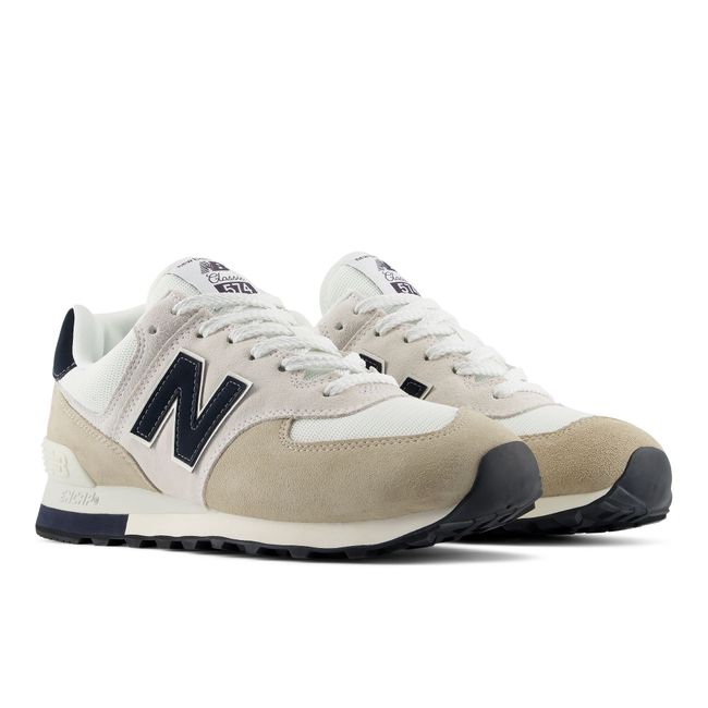 Pair of New Balance 574 sneakers in cream with navy detailing