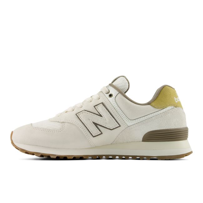 Medial profile of the New Balance 574 in cream suede with olive detailing