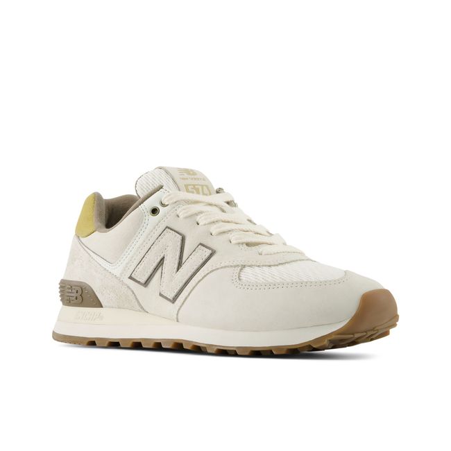 Pair of New Balance 574 sneakers in cream suede with a gum outsole