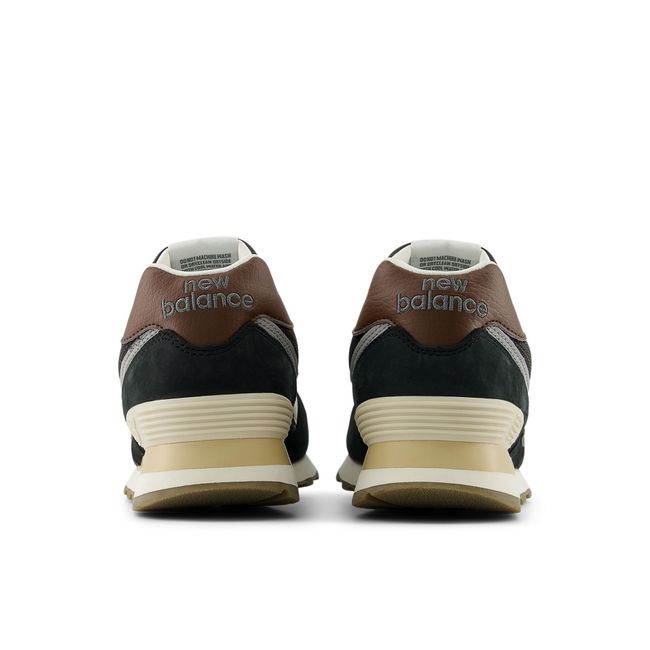 Rear heel view of the New Balance 574 pair in deep brown with a leather heel tab