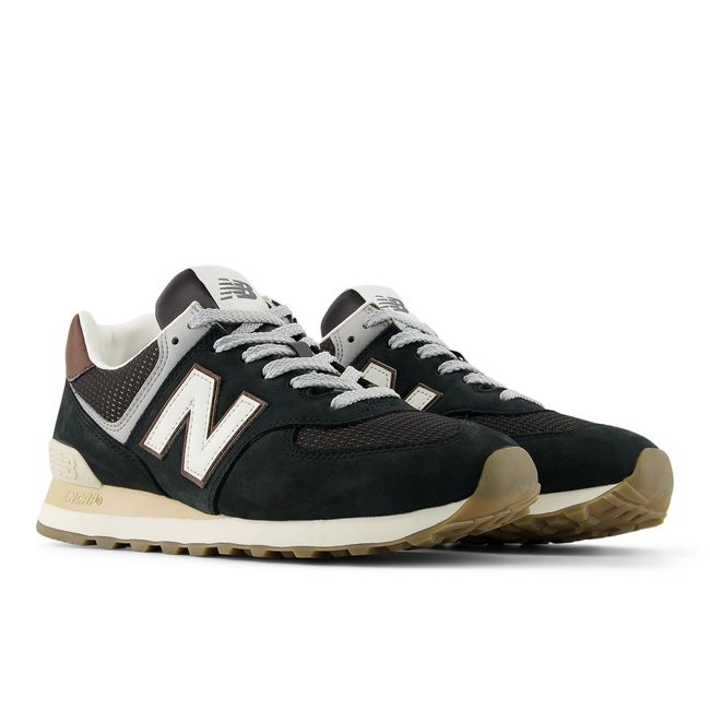 Pair of New Balance 574 sneakers in deep brown suede with a gum outsole