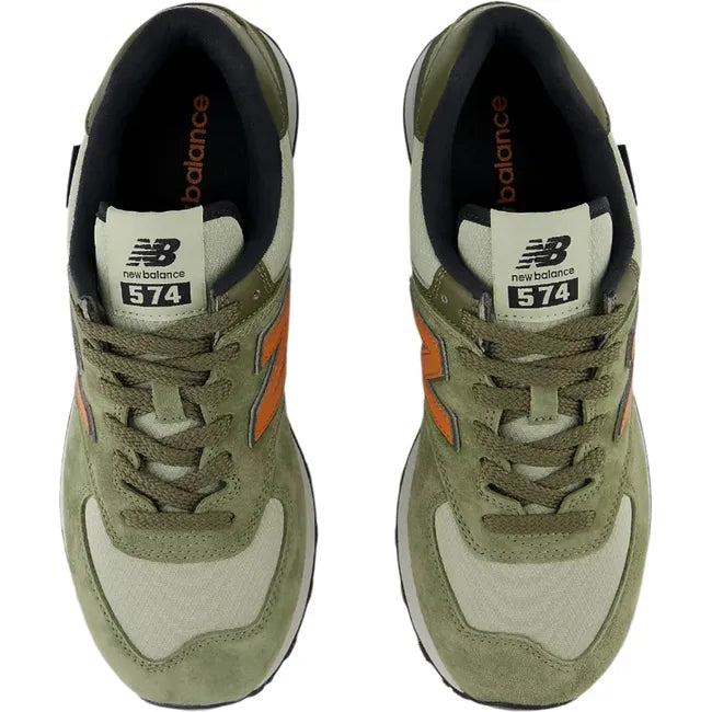 Top-down view of Unisex New Balance 574 sneakers in olive green suede with orange accents.