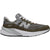 Lateral side of New Balance 990v6 sneakers in suede olive green and gray with a chunky sole.