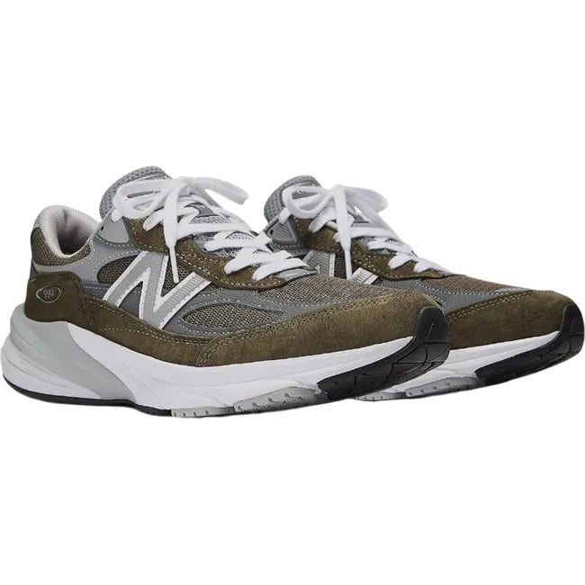 Pair of New Balance 990v6 sneakers in suede olive green and gray with a chunky sole.