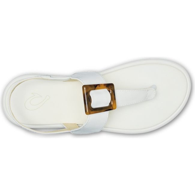 Top down view of women's Olukai Lai T Bar sandal in white leather with brown buckle on instep