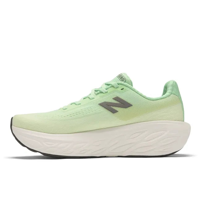 Medial view of light green New Balance women's running shoe with white midsole.