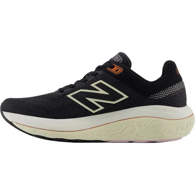 Medial side of New Balance Fresh Foam X 860v14 sneakers in black with orange accents.
