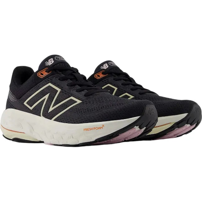 Pair of New Balance Fresh Foam X 860v14 sneakers in black with orange accents.