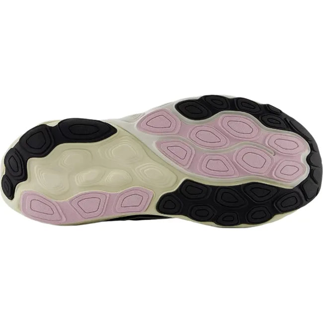 Sole of New Balance Fresh Foam X 860v14 sneakers with black and pink sections of tread.