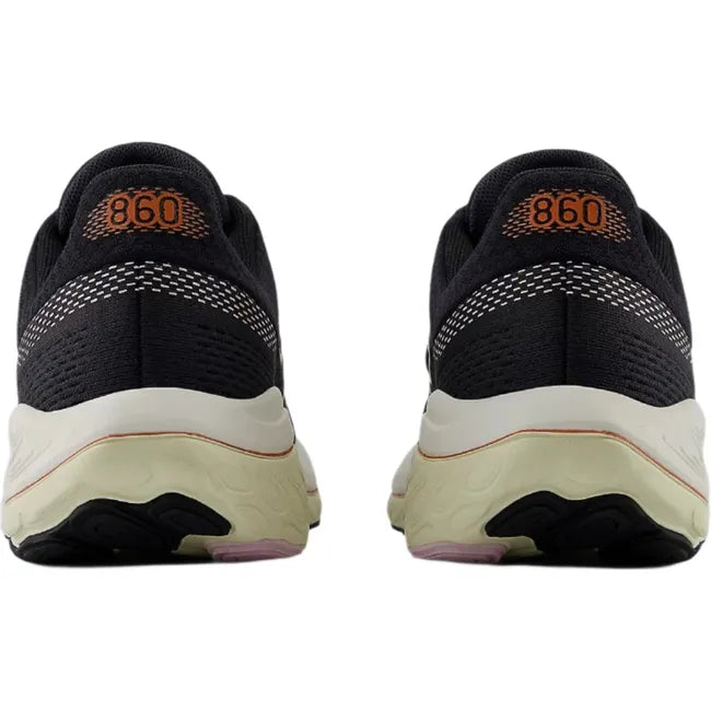 Heels of New Balance Fresh Foam X 860v14 sneakers in black with orange accents.