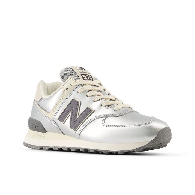 Pair of New Balance 574 sneakers in metallic silver and cream